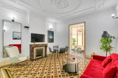 a living room with a red couch and a fireplace at Tendency Apartments 6 in Barcelona