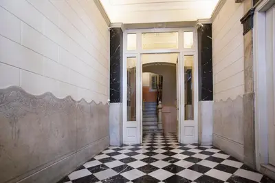 an empty hallway with a black and white checkered floor at Tendency Apartments 6 in Barcelona