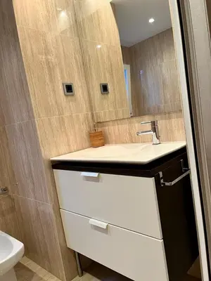 a bathroom with a sink and a mirror at Large Apartment near FIRA and City Center in Hospitalet de Llobregat
