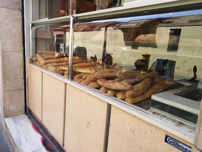 a display window of a bakery with lots of bread at ApartEasy - Atic Sants in Barcelona