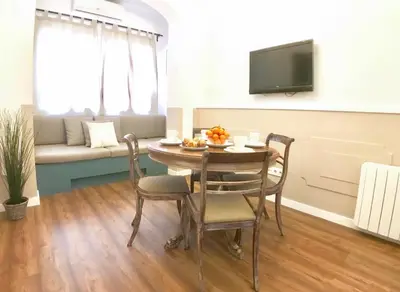 a living room with a table and chairs and a couch at LEPANTO APARTMENTS 150m FROM SAGRADA FAMILIA in Barcelona