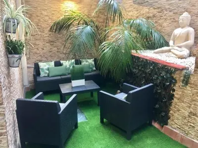 a patio with chairs and a couch and a table at Front Arc in Barcelona