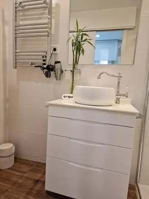 a white bathroom with a sink and a mirror at Front Arc in Barcelona