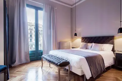 a bedroom with a large bed and a window at BacHome Gallery B&B in Barcelona