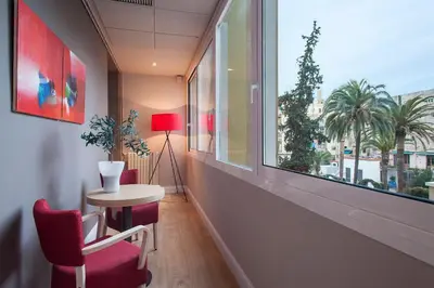 a room with a table and chairs and a window at BacHome Gallery B&B in Barcelona