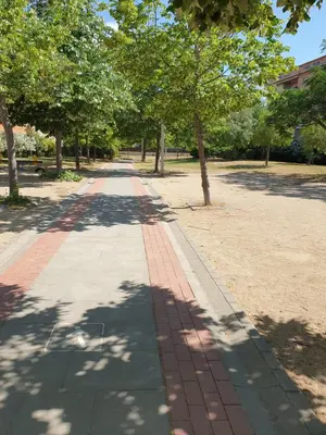 a walkway with trees in a park at Appartement 6 Personnes - L'arboc in Arbós