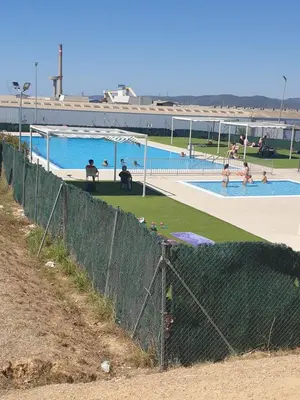 a swimming pool with people in the water at Appartement 6 Personnes - L'arboc in Arbós