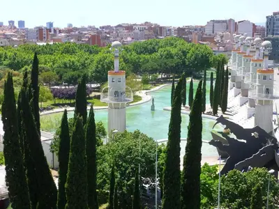 a view of a park with trees and a fountain at La Fira in Barcelona