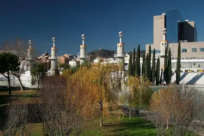 a group of trees and buildings in a city at La Fira in Barcelona