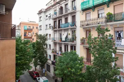 a tall white building with trees in front of it at Molino Fresh in Barcelona