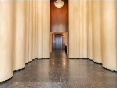 a hallway lined with curtains in a building at Modernismo Paseo de Gracia in Barcelona