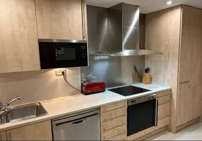 a kitchen with a sink and a microwave at Modernismo Paseo de Gracia in Barcelona