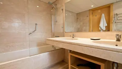 a bathroom with a sink and a shower and a tub at Modernismo Paseo de Gracia in Barcelona
