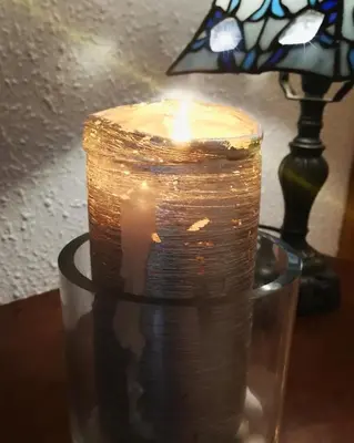a candle sitting on a table next to a lamp at Ca la Carmeta in Cunit