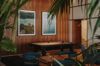 a courtyard with couches and tables in front of a building at Sabàtic Sitges Hotel, Autograph Collection in Sitges