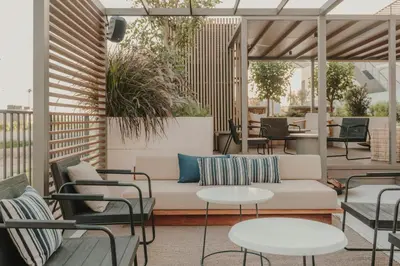 a restaurant with tables and chairs and windows at Sabàtic Sitges Hotel, Autograph Collection in Sitges