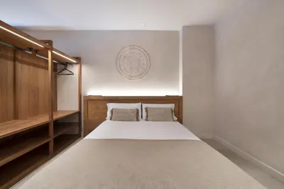 a bedroom with a large bed with two pillows at Apartamentos Balisse in Castelldefels