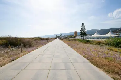 a walking path in the middle of a field with tents at Apartamentos Balisse in Castelldefels