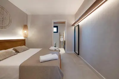 a bedroom with two beds with white towels on them at Apartamentos Balisse in Castelldefels