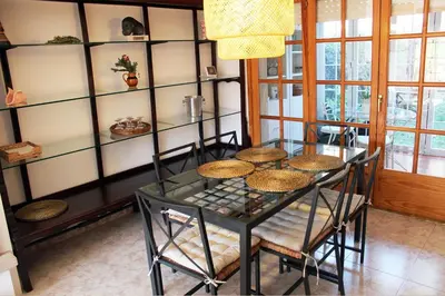 a dining room with a glass table and chairs at VACACIONES EN MARESME CASA PARA 7 PERSONAS in Sant Iscle de Vallalta