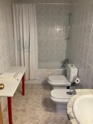 a bathroom with a white toilet and a sink at VACACIONES EN MARESME CASA PARA 7 PERSONAS in Sant Iscle de Vallalta