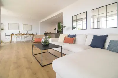 a living room with a white couch and a table at Vivalidays Apartour - Calella in Calella