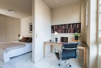 a bedroom with a bed and a desk with a computer at Glocal Apartments Barcelona in Barcelona