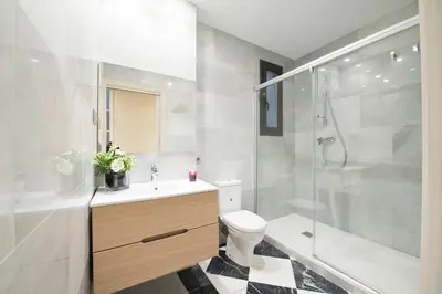 a bathroom with a toilet sink and a shower at Glocal Apartments Barcelona in Barcelona