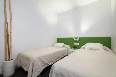 a bedroom with two beds and a large mirror at The Collection Barcelona - 3-bedroom penthouse with terrace in Eixample in Barcelona