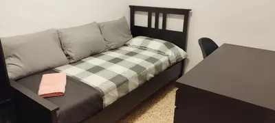 a couch with a pillow and a table in a room at Apartamento entero con terraza en el centro de Rubí in Rubí