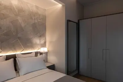 a bedroom with a large bed and a wall at AB BOUTIQUE HOTEL - Adults only in Sant Vicenç de Montalt