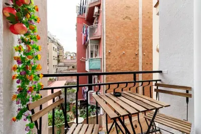 a balcony with a wooden table and two benches at Stay U-nique Apartments La Bordeta in Barcelona