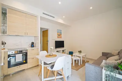 a kitchen and living room with a table and a couch at NICE CENTRIC APARTMENT in Vilanova i la Geltrú