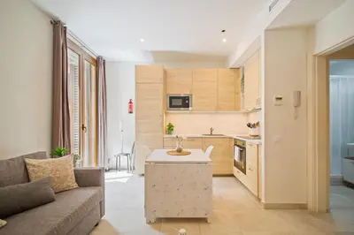 a living room with a couch and a kitchen at NICE CENTRIC APARTMENT in Vilanova i la Geltrú