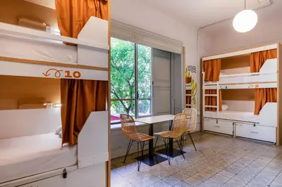 a hallway of a house with windows and a bed at The Loft House Barcelona in Barcelona