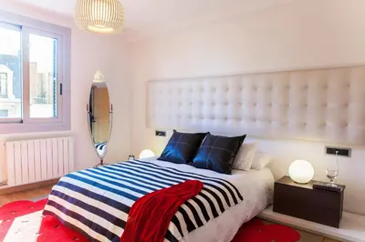 a bedroom with a large bed and a window at BizFlats Eixample Apartments in Barcelona