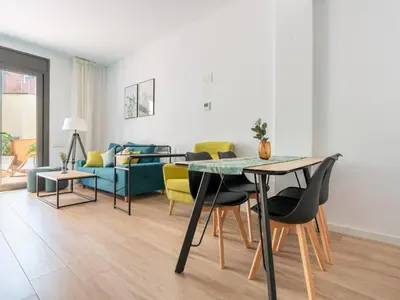 a living room with a table and a couch at Limehome Barcelona Carrer de Besalú 90 - estancia temporal in Barcelona
