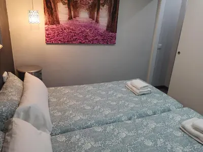 a bedroom with a bed and a painting on the wall at ApartEasy - Eixample Center in Barcelona