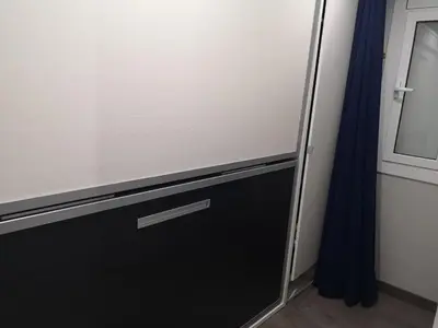 a sliding glass door with a blue curtain at ApartEasy - Eixample Center in Barcelona