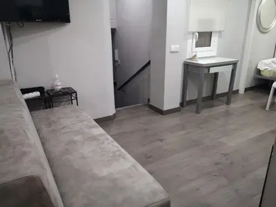 a living room with a couch and a table at ApartEasy - Eixample Center in Barcelona