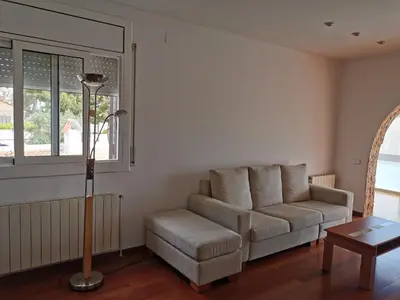 a living room with a couch and a table at Villa Playa y Montaña in Cunit