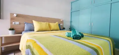 a bedroom with a bed with a purse on it at Casa Petits in Manresa