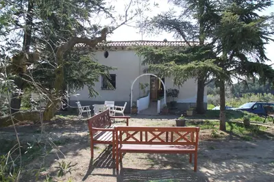 a bench sitting in front of a house at MAS GUILLO in San Quintín de Mediona