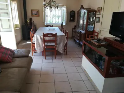 a living room with a table and a couch at MAS GUILLO in San Quintín de Mediona