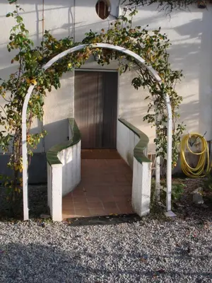 an arbor with an entrance to a building at MAS GUILLO in San Quintín de Mediona