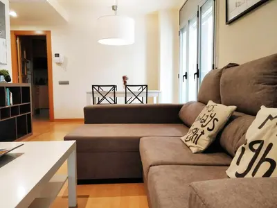 a living room with a couch and a table at Mazi Apartments Downtown in Mataró