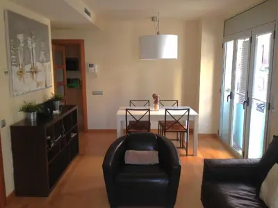 a living room with a table and a chair at Mazi Apartments Downtown in Mataró