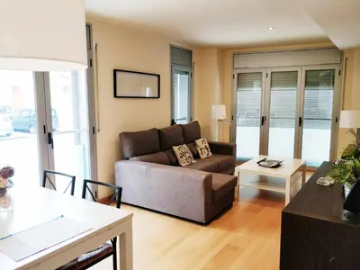a living room with a couch and a table at Mazi Apartments Downtown in Mataró