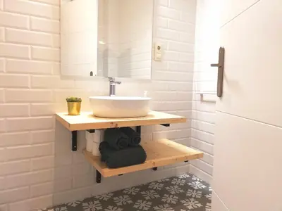 a bathroom with a sink and a mirror at Mazi Apartments Chic in Badalona