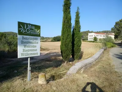 a sign for a villa next to a road at LA NURSERY DE MAS GUILLO in San Quintín de Mediona